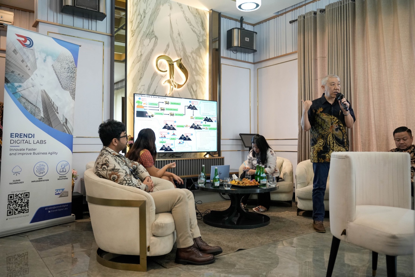 Industry process discussion with an Erendi banner and a coal movement diagram on screen